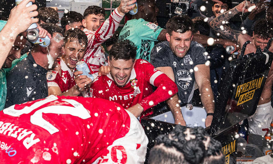 Wrexham AFC celebrating their promotion spraying cans of Wrexham Lager