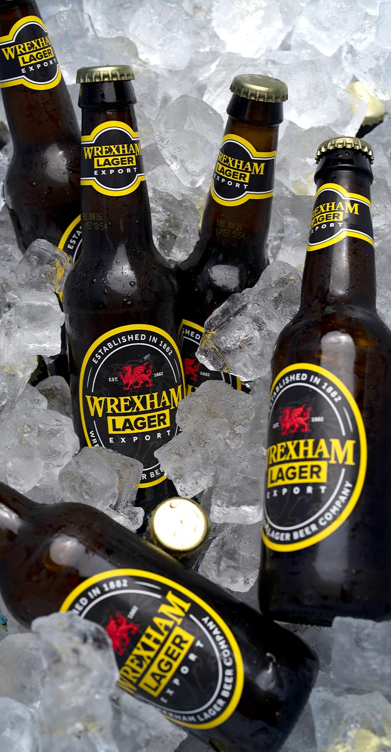 Wrexham Lager bottles on ice with a lit candle